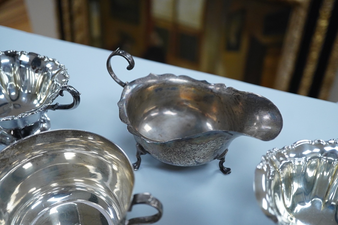 A collection of small silver wares to include a George V silver porringer, two George V silver sauce boats, a let Victorian silver sugar bowl, a George III silver goblet, with later embossed decoration, a George V small